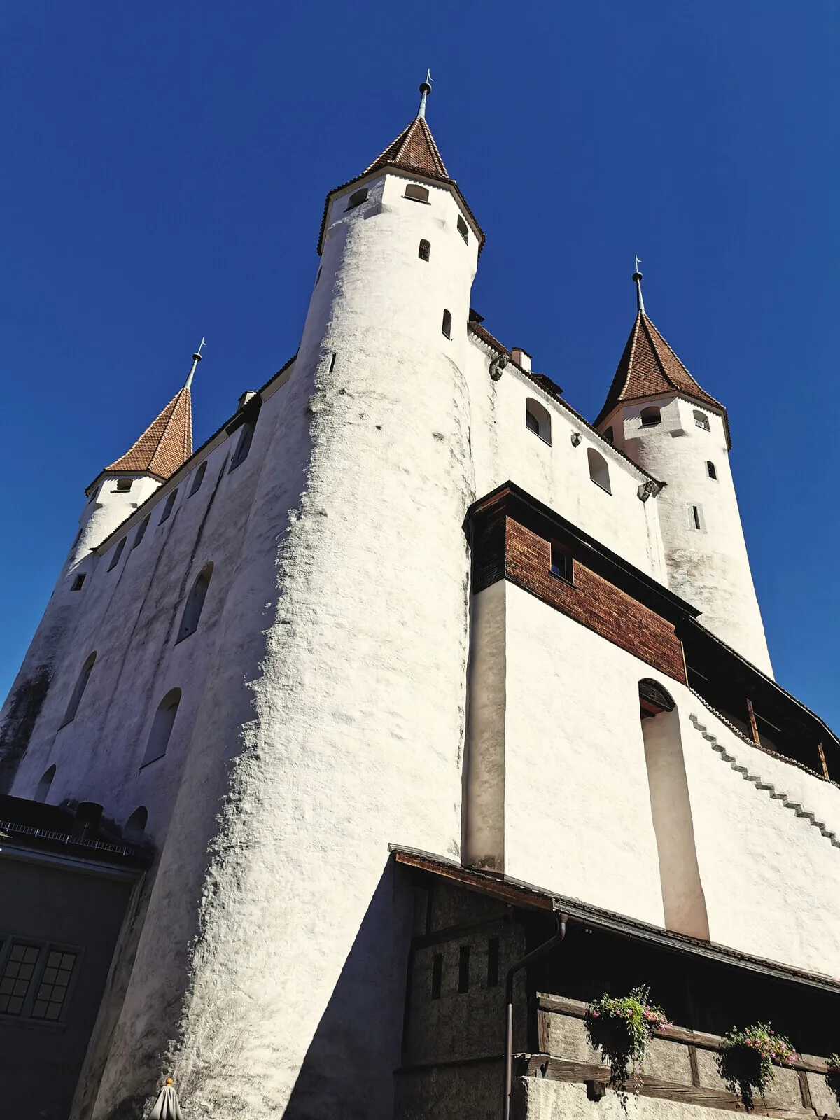Thun castle from below, its towers against the sky.