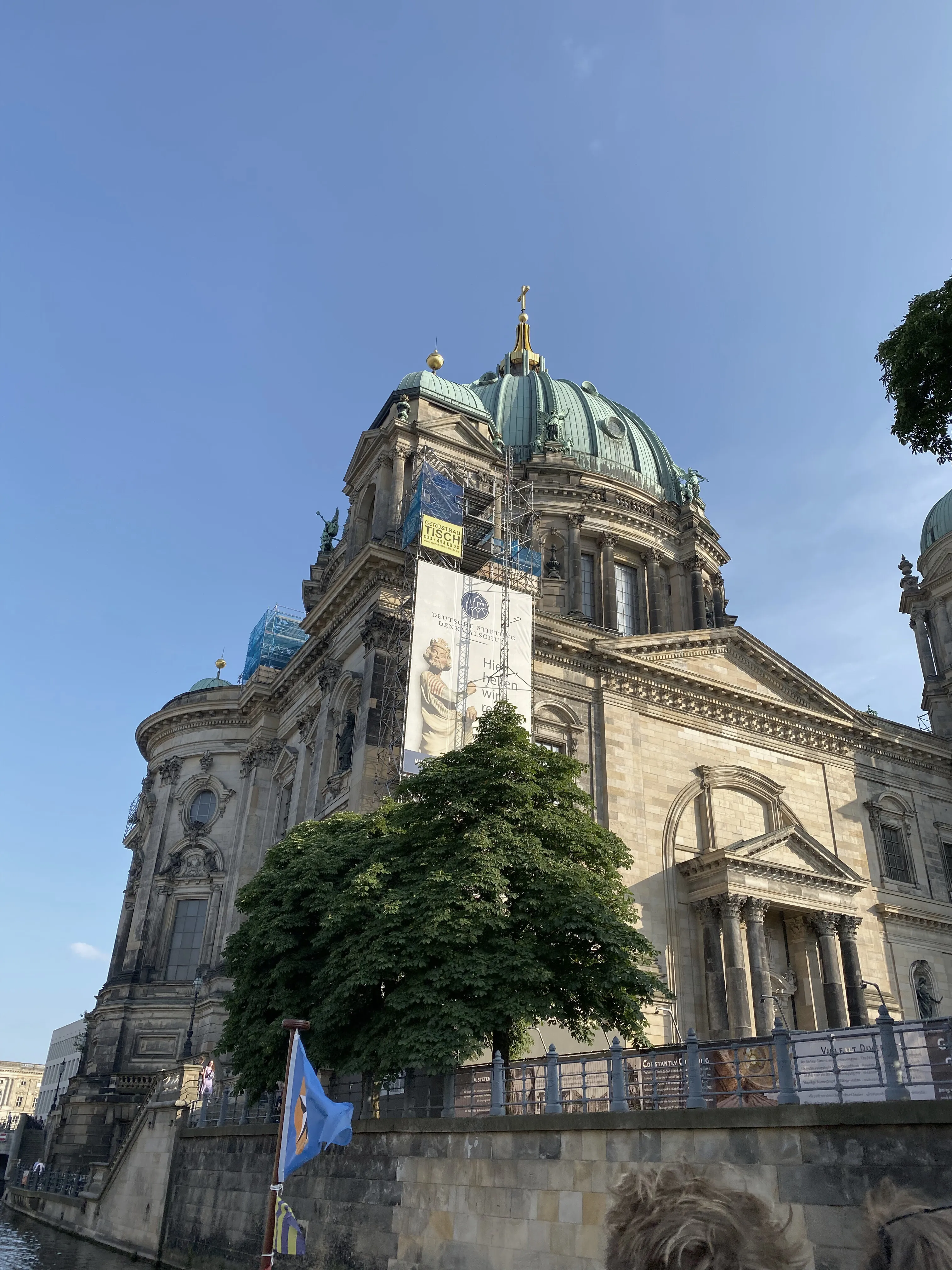 Berlin cathedral from below, its dome against a clear sky.