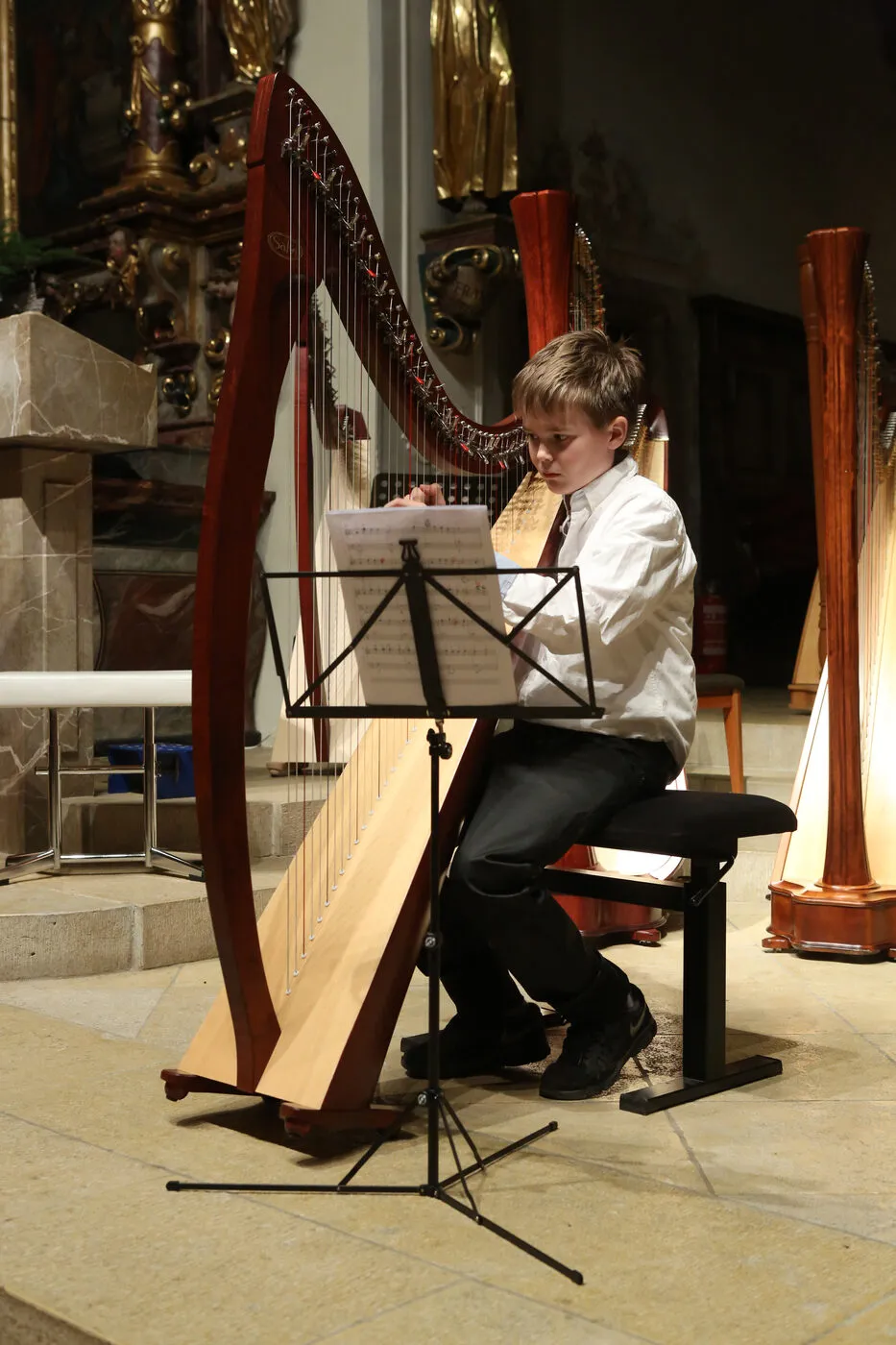 Playing the harp in a church as a boy.