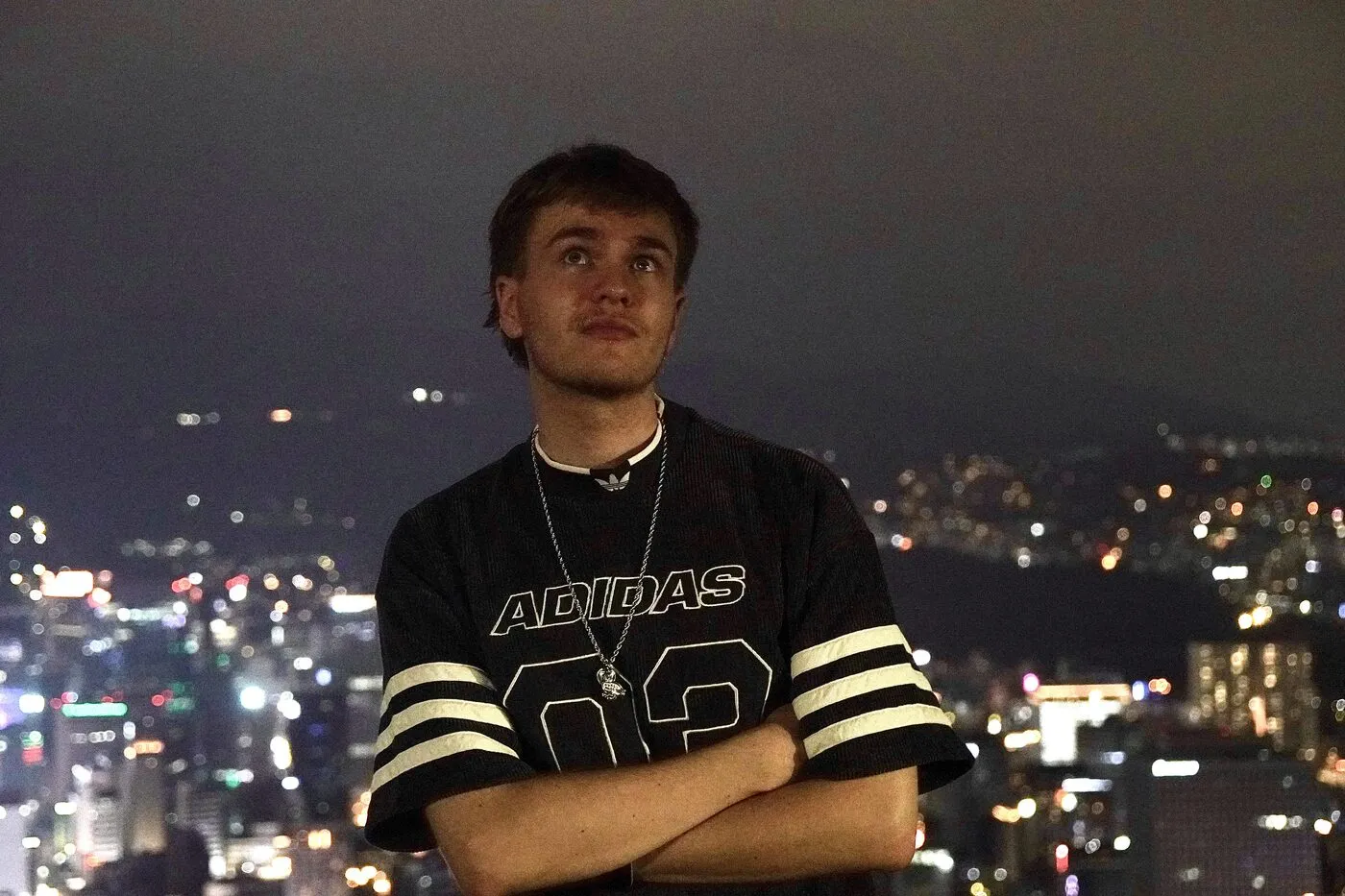 Standing in front of a city at night.